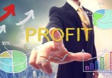 Business man pointing PROFIT with colorful graphs